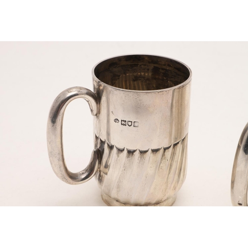 280 - TWO 20TH CENTURY SILVER MUGS. one with a fluted lower body and a collet foot, by William Hutton & So... 