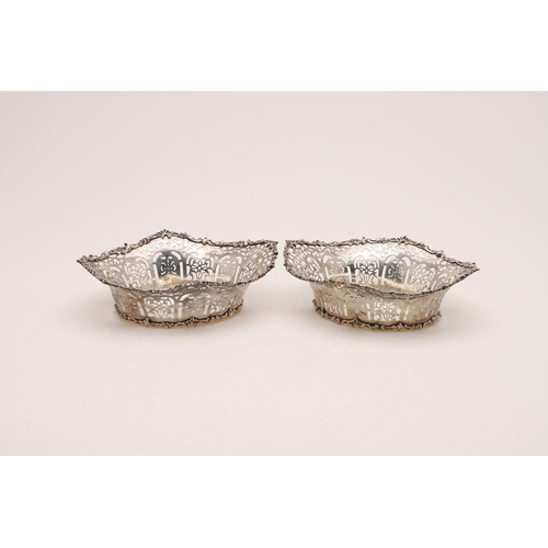 284 - A PAIR OF EDWARDIAN BASKETS. oval outline, with pierced sides and foliate scroll borders, by William... 