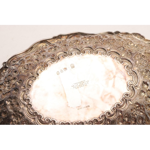 291 - A VICTORIAN EMBOSSED BONBON DISH. shaped oval outline, with a scroll border and engraved in the cent... 