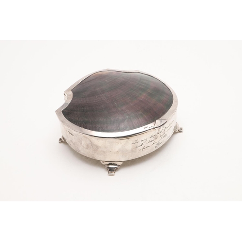 316 - A GEORGE V DRESSING TABLE BOX. shell-shaped, the cover inset with mother-of-pearl and raised on four... 