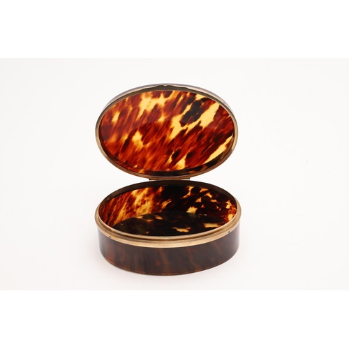 319 - A GEORGE V 9CT. GOLD MOUNTED TORTOISESHELL BOX. oval form, with a band of 9ct. gold around both rims... 