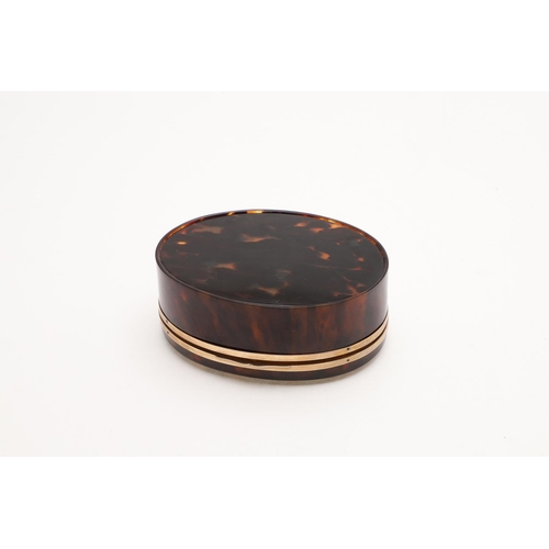 319 - A GEORGE V 9CT. GOLD MOUNTED TORTOISESHELL BOX. oval form, with a band of 9ct. gold around both rims... 