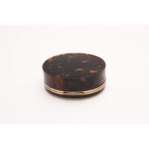 319 - A GEORGE V 9CT. GOLD MOUNTED TORTOISESHELL BOX. oval form, with a band of 9ct. gold around both rims... 