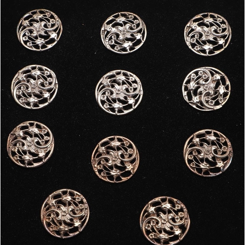 330 - BUTTONS:-. a set of 11 Edwardian buttons, with pierced floral decoration, by Lawrence Emanuel, Birmi... 