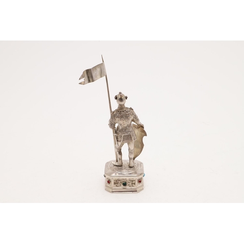 347 - A 20TH CENTURY GERMAN FIGURE OF A KNIGHT. with a flag in his left hand and resting on a shield in hi... 