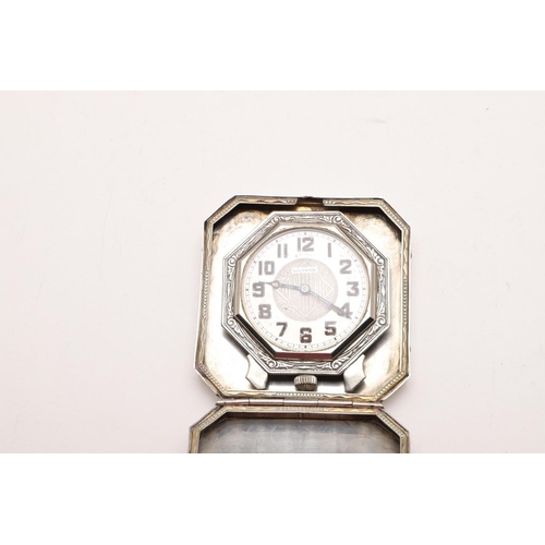 349 - A LATE 19TH/ EARLY 20TH CENTURY NORTH AMERICAN TRAVEL CLOCK. of octagonal form,  with engine-turned ... 