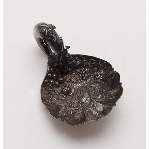 36 - A VICTORIAN CADDY SPOON. with stamped decoration and the crescent handle with applied fruiting vines... 