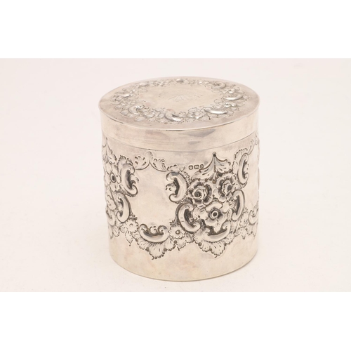 411 - A LATE VICTORIAN EMBOSSED CANNISTER. cylindrical form, decorated in relief with floral scrolls, with... 