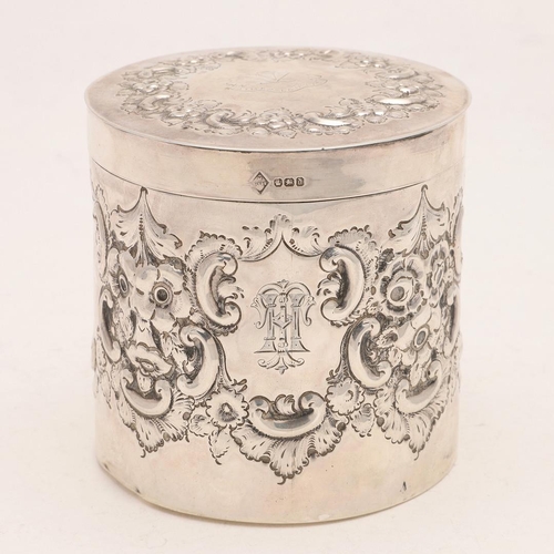 411 - A LATE VICTORIAN EMBOSSED CANNISTER. cylindrical form, decorated in relief with floral scrolls, with... 