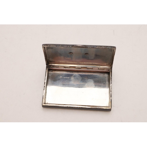 413 - A 20TH CENTURY CONTINENTAL SILVER & BLACK ENAMEL BOX. rectangular, with engraved borders and an appl... 