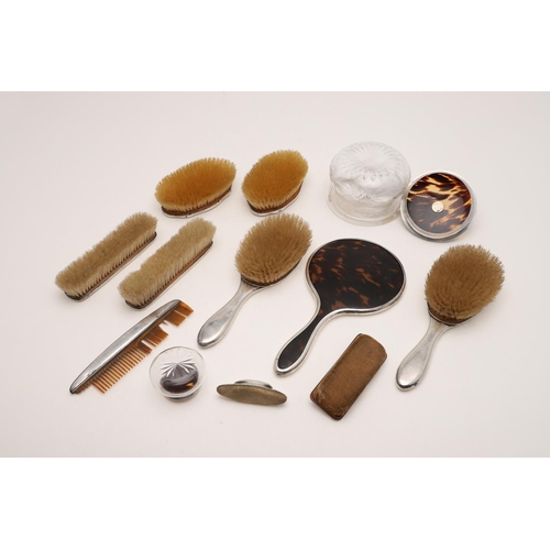 425 - MIXED TORTOISESHELL MOUNTED DRESSING TABLE ITEMS:-. two pairs of brushes and a hand mirror, by Horto... 