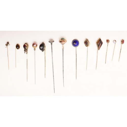 435 - THIRTEEN VARIOUS HAT PINS. including gold mounted examples, 2 tigers eye pins, a silver pin, one dec... 