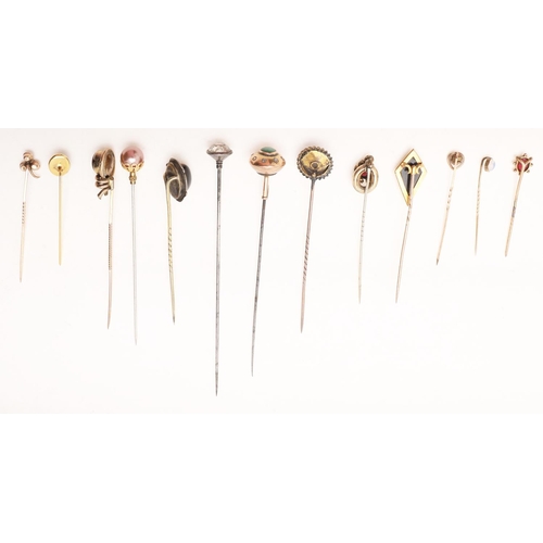 435 - THIRTEEN VARIOUS HAT PINS. including gold mounted examples, 2 tigers eye pins, a silver pin, one dec... 