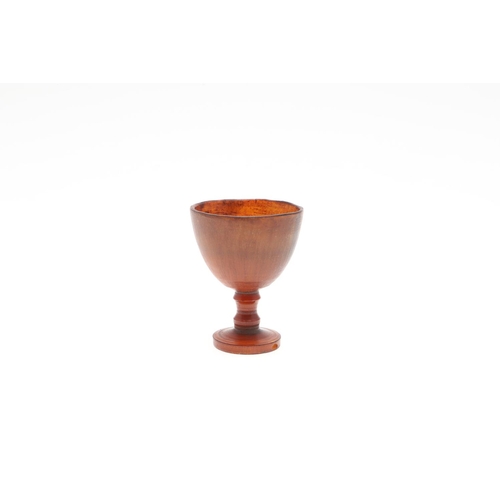 444 - AN ANTIQUE RHINO HORN SMALL CUP. with ovoid bowl and turned stem, 6cm high.  generally good.