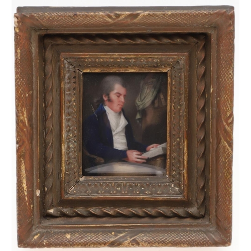 454 - A GEORGE III MINIATURE PORTRAIT. of a gentleman seated in an interior reading a book, three quarter ... 