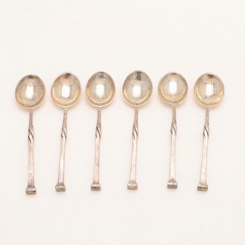 86 - A GEORGE V CASED SET OF SIX TEASPOONS, BY OMAR RAMSDEN. with twist stems and a spot hammered finish,... 