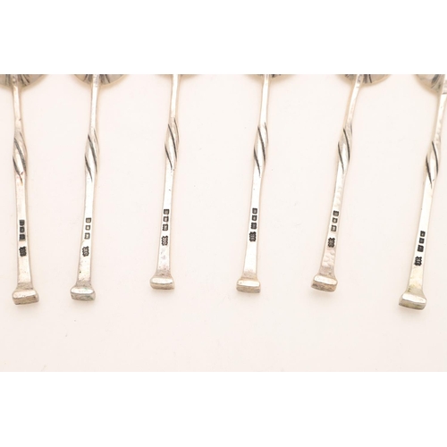 86 - A GEORGE V CASED SET OF SIX TEASPOONS, BY OMAR RAMSDEN. with twist stems and a spot hammered finish,... 