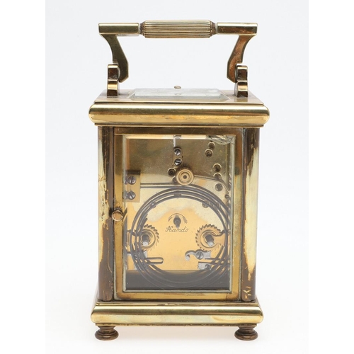 1421 - A BRASS REPEATING CARRIAGE CLOCK. the enamelled dial with Arabic numerals and scrolling central deco... 