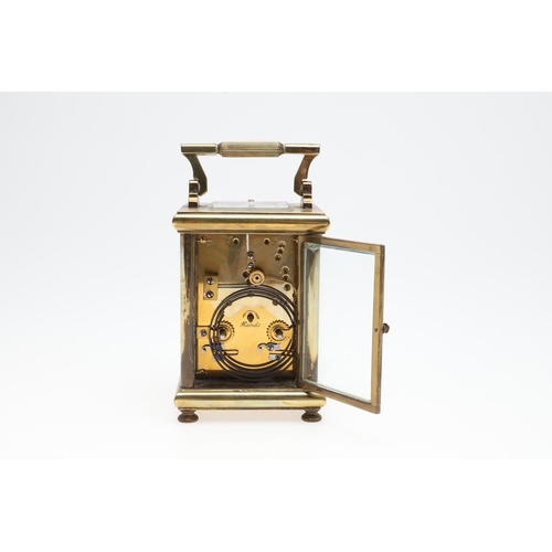 1421 - A BRASS REPEATING CARRIAGE CLOCK. the enamelled dial with Arabic numerals and scrolling central deco... 