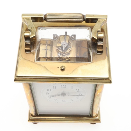 1421 - A BRASS REPEATING CARRIAGE CLOCK. the enamelled dial with Arabic numerals and scrolling central deco... 