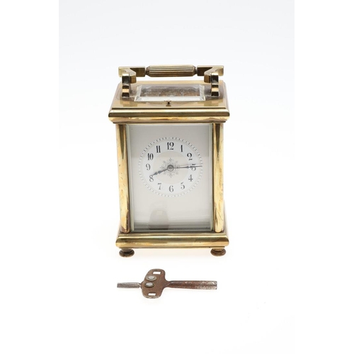 1421 - A BRASS REPEATING CARRIAGE CLOCK. the enamelled dial with Arabic numerals and scrolling central deco... 