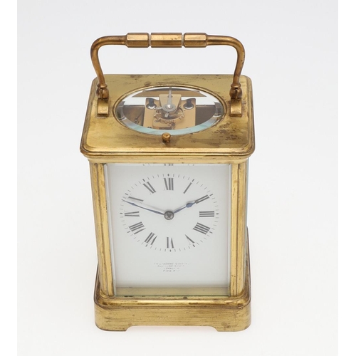 1426 - AN EARLY 20TH CENTURY FRENCH BRASS REPEATING CARRIAGE CLOCK. the enamel dial signed Goldsmiths' Comp... 