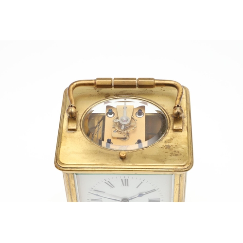 1426 - AN EARLY 20TH CENTURY FRENCH BRASS REPEATING CARRIAGE CLOCK. the enamel dial signed Goldsmiths' Comp... 