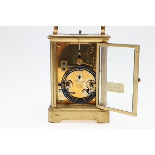 1426 - AN EARLY 20TH CENTURY FRENCH BRASS REPEATING CARRIAGE CLOCK. the enamel dial signed Goldsmiths' Comp... 