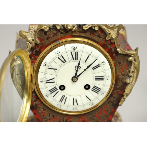 1428 - A 20TH CENTURY FRENCH BOULLE EFFECT CLOCK GARNITURE. the clock with enamel dial above a visible pend... 