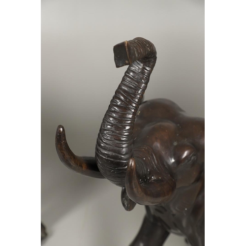 1452 - A PAIR OF LARGE BRONZE ELEPHANTS. hollow cast, modelled charging with trunks raised, height 125cm, l... 