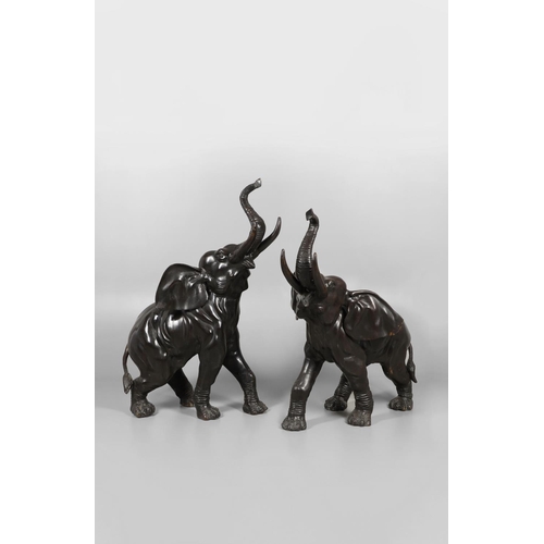 1452 - A PAIR OF LARGE BRONZE ELEPHANTS. hollow cast, modelled charging with trunks raised, height 125cm, l... 