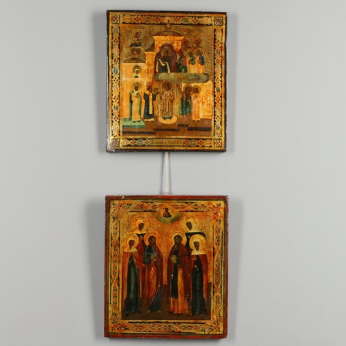 1462 - A PAIR OF RUSSIAN ICONS. 20th century, depicting saintly figures between stylised gilt borders, 31cm... 