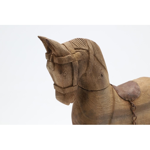 1463 - A CARVED WOODEN TOY ROCKING HORSE. with metal saddle and tail upon a metal rocker, height 44cm, widt... 