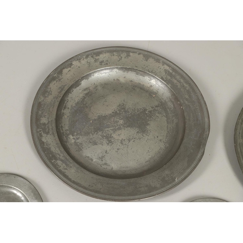 1468 - A PAIR OF LARGE 18TH CENTURY PEWTER PLATES. the rims with reeded border, stamped maker's mark to ver... 