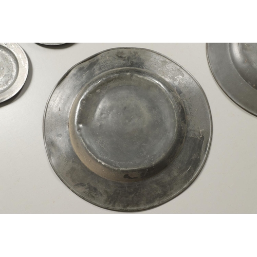 1468 - A PAIR OF LARGE 18TH CENTURY PEWTER PLATES. the rims with reeded border, stamped maker's mark to ver... 