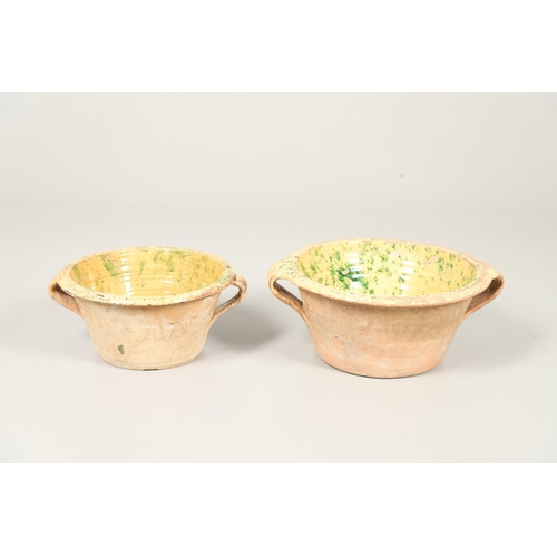 1473 - A 19TH CENTURY POTTERY DAIRY TWO HANDLED BOWL. the interior with mustard yellow glaze and green spon... 