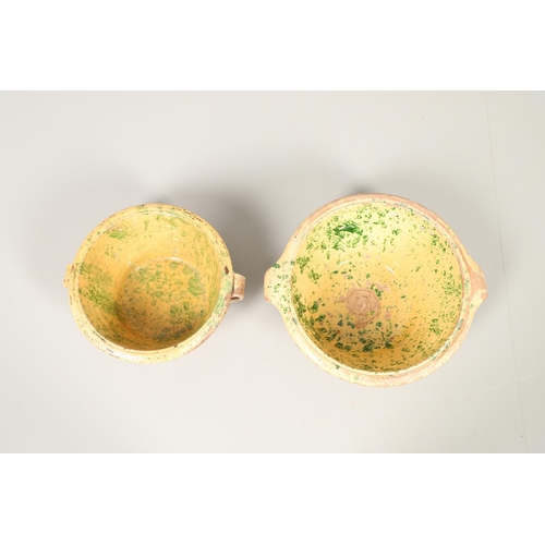 1473 - A 19TH CENTURY POTTERY DAIRY TWO HANDLED BOWL. the interior with mustard yellow glaze and green spon... 