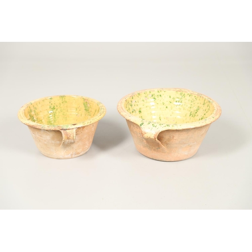 1473 - A 19TH CENTURY POTTERY DAIRY TWO HANDLED BOWL. the interior with mustard yellow glaze and green spon... 