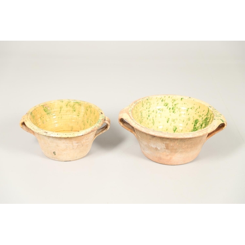 1473 - A 19TH CENTURY POTTERY DAIRY TWO HANDLED BOWL. the interior with mustard yellow glaze and green spon... 