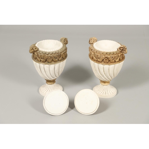 1496 - A PAIR OF REGENCY STYLE RESIN URNS AND COVERS. the lobed bodies with gold painted swag and acanthus ... 