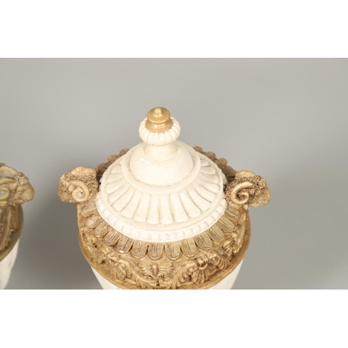 1496 - A PAIR OF REGENCY STYLE RESIN URNS AND COVERS. the lobed bodies with gold painted swag and acanthus ... 