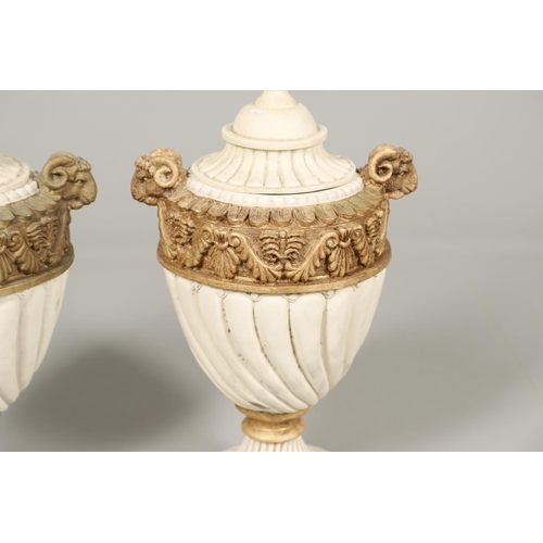 1496 - A PAIR OF REGENCY STYLE RESIN URNS AND COVERS. the lobed bodies with gold painted swag and acanthus ... 