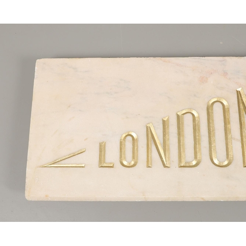 1503 - A PALE PINK MARBLE 'LONDON PAVILION' PLAQUE. the carved lettering in gilt, height 38cm, length 130cm... 