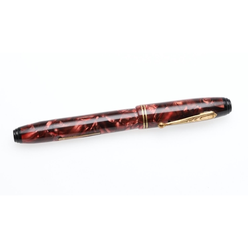 1517 - A PARKETTE LEVERFILL FOUNTAIN PEN. in pink marbled resin with two narrow bands to cap, the nib marke... 