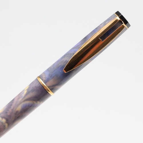 1519 - A GROUP OF WATERMAN FOUNTAIN PENS. comprising a Phileas red marbled bodied pen, a 1990s purple feath... 