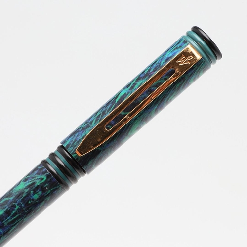 1519 - A GROUP OF WATERMAN FOUNTAIN PENS. comprising a Phileas red marbled bodied pen, a 1990s purple feath... 