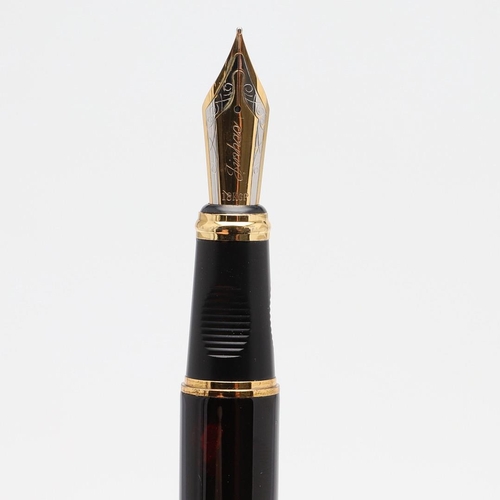 1522 - JINHAO: FOUR FOUNTAIN PENS. comprising a black barrelled example with a Chinese figure of a wise man... 