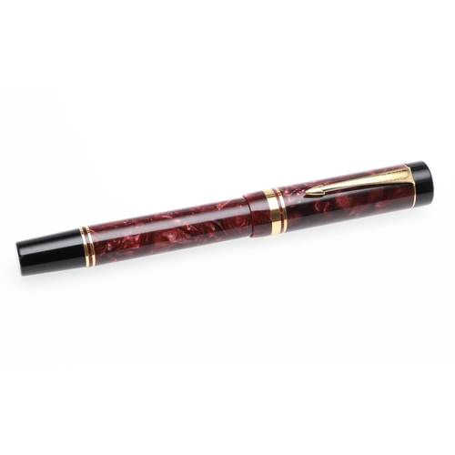 1524 - A PARKER DUOFOLD CENTENNIAL FOUNTAIN PEN. with marbled red resin barrel and cap, the nib marked 18k ... 