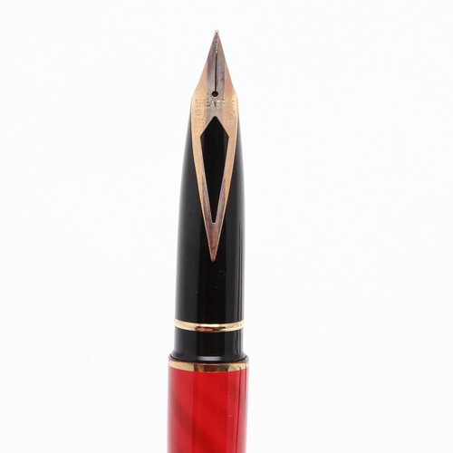 1528 - A SHEAFFER TARGA FOUNTAIN PEN. the red case with gold tone trim and white dot to cap, 14k nib; and a... 