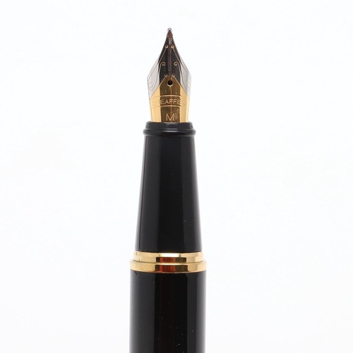 1528 - A SHEAFFER TARGA FOUNTAIN PEN. the red case with gold tone trim and white dot to cap, 14k nib; and a... 